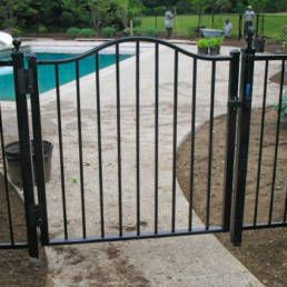 Black Wrought Iron Gatleading To A Swimming Pool — Warren, MI — Kimberly Fence & Supply