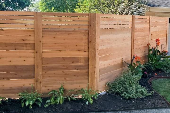 Wooden Fence Surrounded By Plants — Warren, MI — Kimberly Fence & Supply