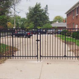 Black Wrought Iron Gate Is Sitting On The Sidewalk — Warren, MI — Kimberly Fence & Supply