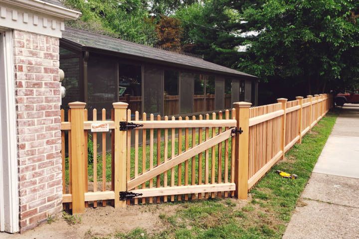 Fence With A Gate In Front Of A Brick House — Warren, MI — Kimberly Fence & Supply