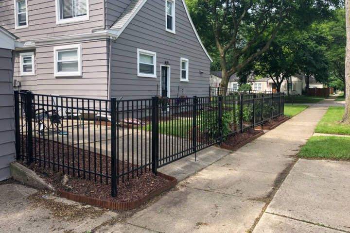 A Gray House With A Black Fence — Warren, MI — Kimberly Fence & Supply