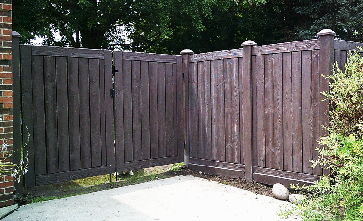 Fence Along A Sidewalk Next To A House — Warren, MI — Kimberly Fence & Supply