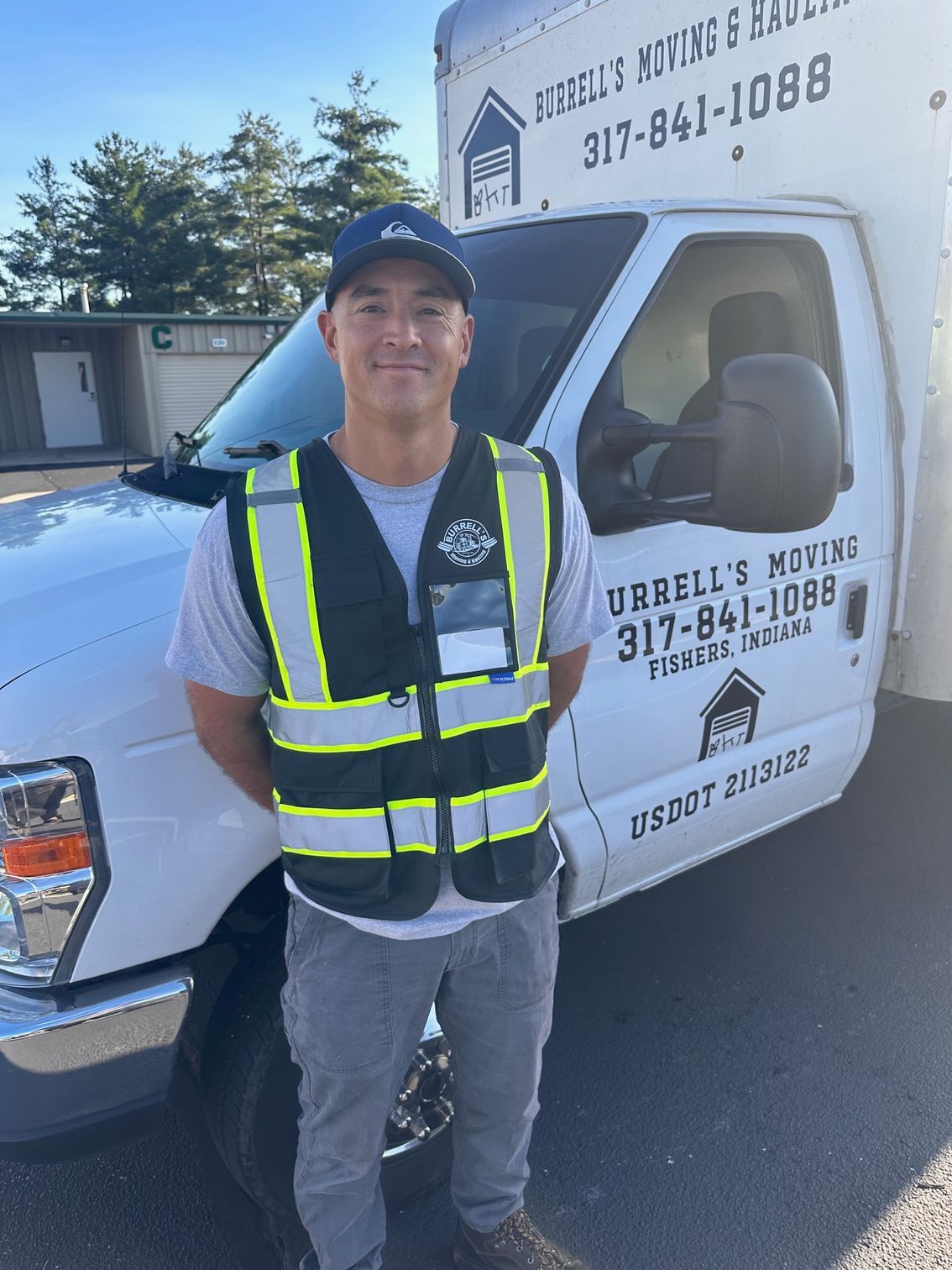 worker loading belongings into a hauling truck/van for moving