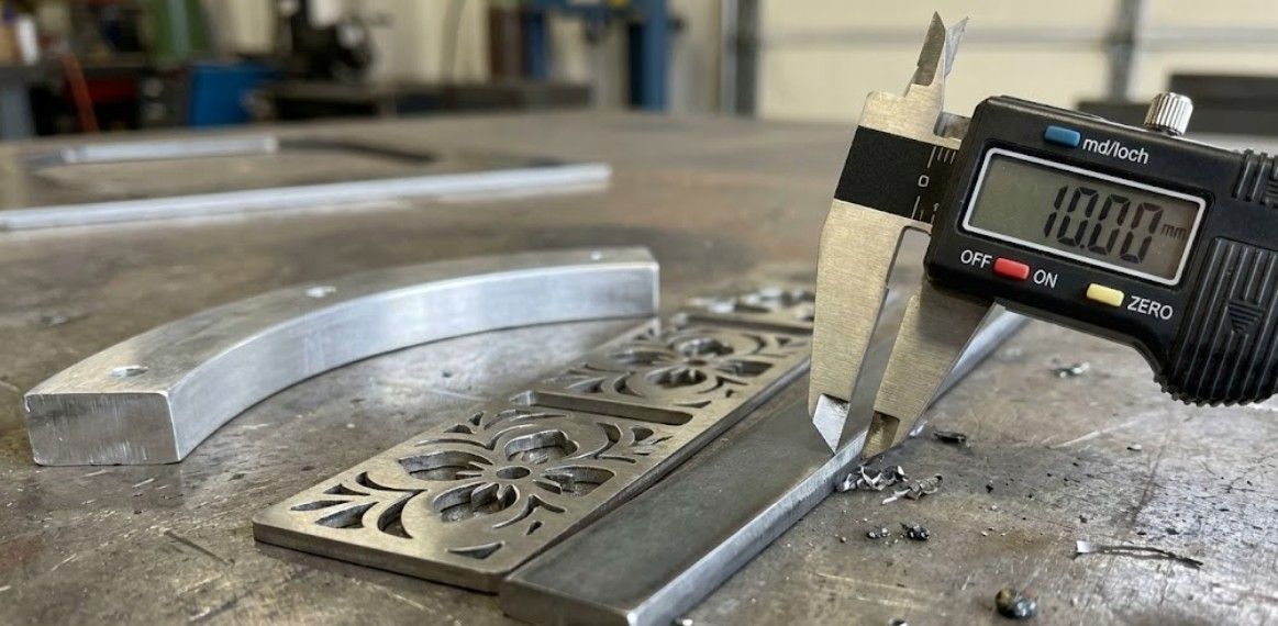 Close-up of precision CNC plasma cut edges showing clean cuts in various metals
