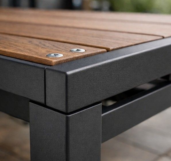 Construction detail of bespoke metal garden table showing steel frame, timber top and quality stainless steel fixings in Nottingham workshop