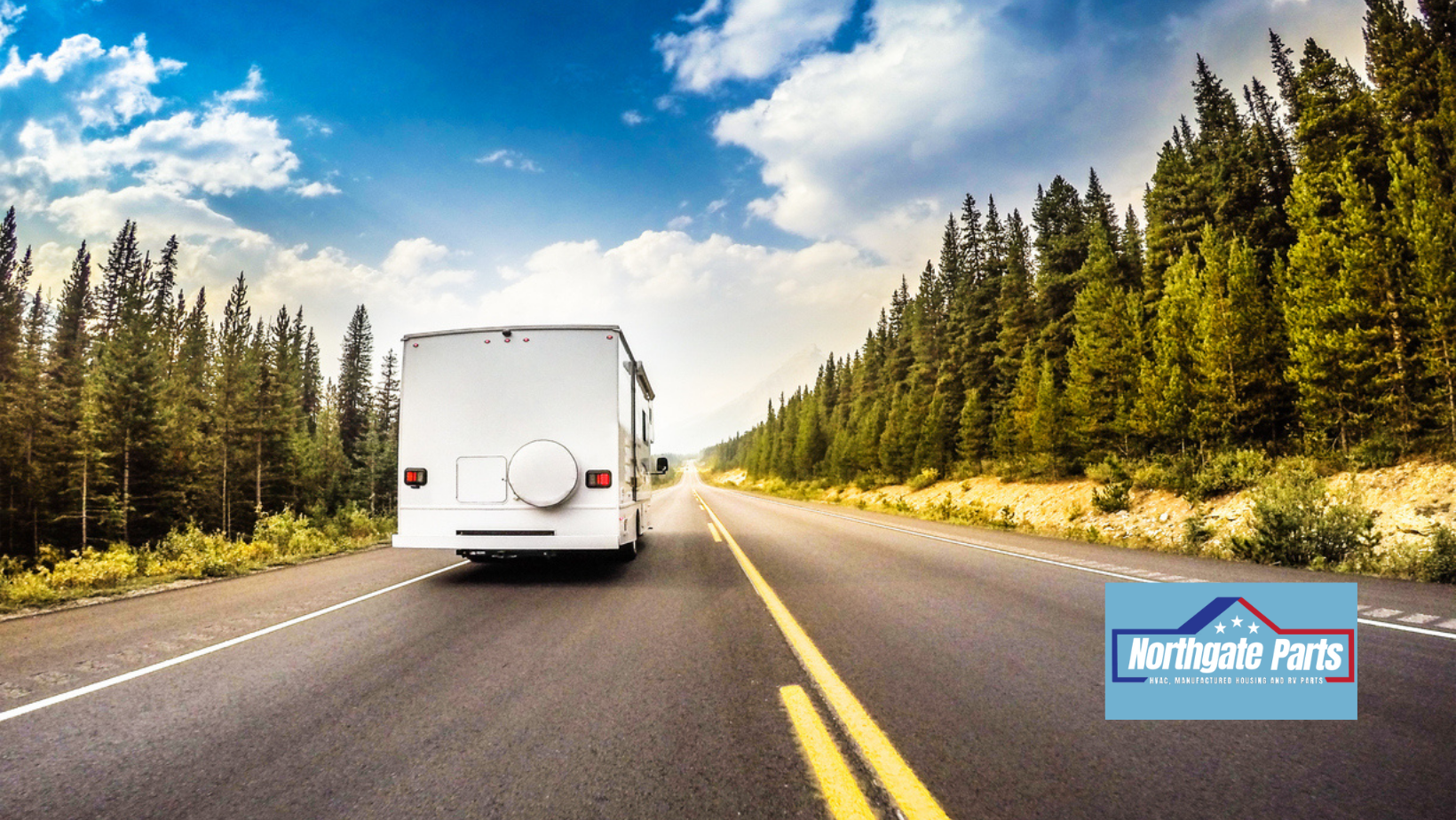 White RV driving down a scenic road with trees on either side under a bright sky.