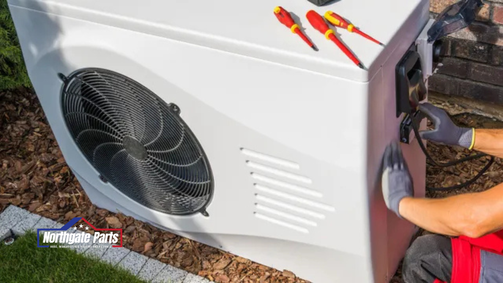 A person is working on an air conditioner outside of a house.