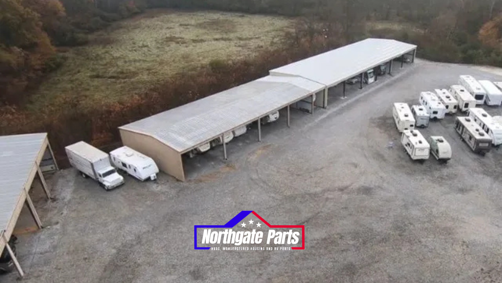 An aerial view of a parking lot with rvs parked under a canopy.
