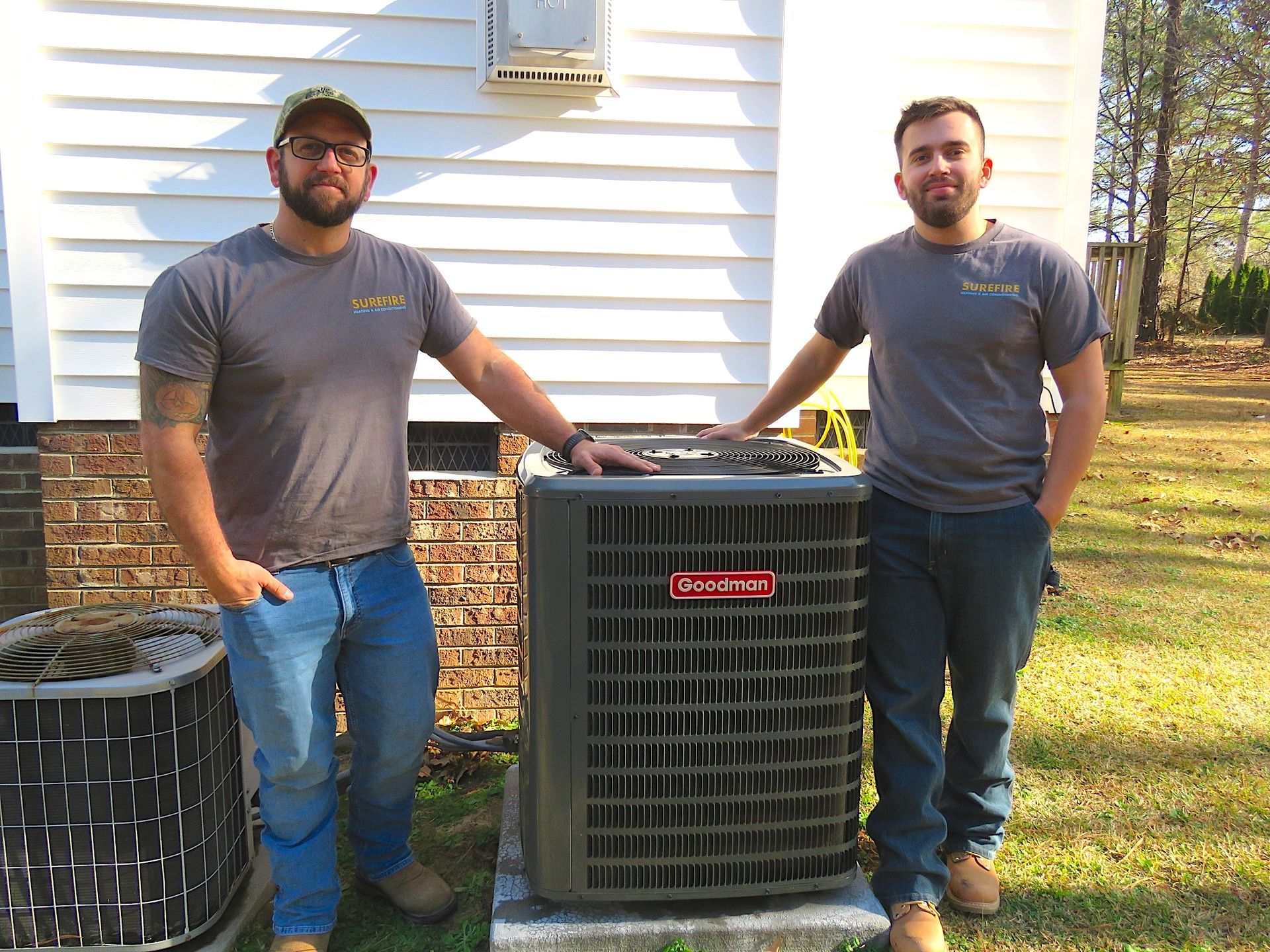 Surefire owner Joey Casertano Jr and employee with Goodman ac unit HVAC Raleigh installation