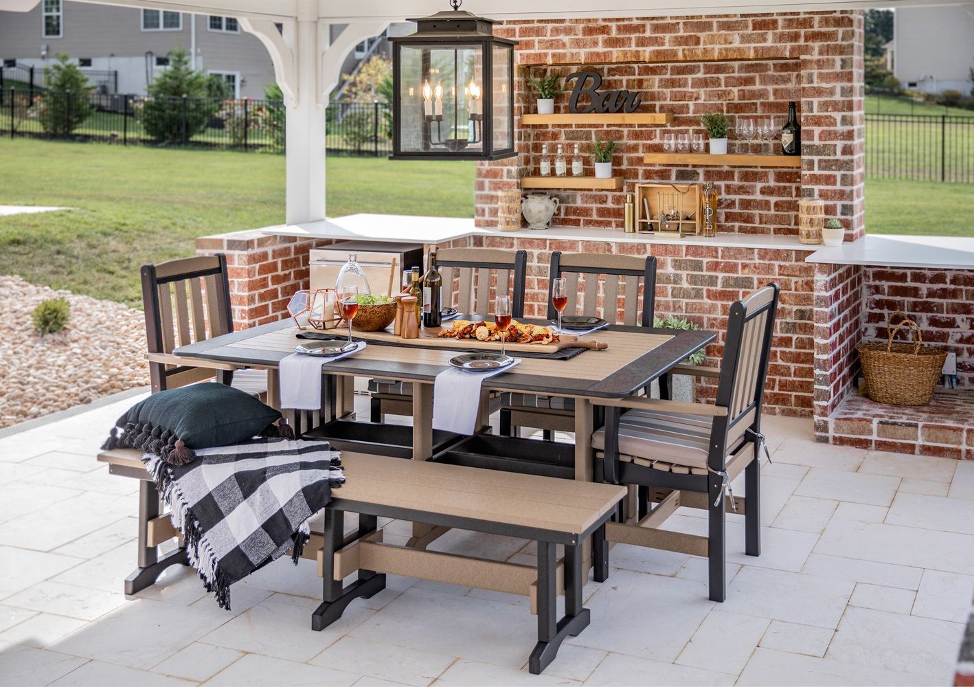 A patio with a table and chairs and a bench. A patio with a table and chairs and a bench.