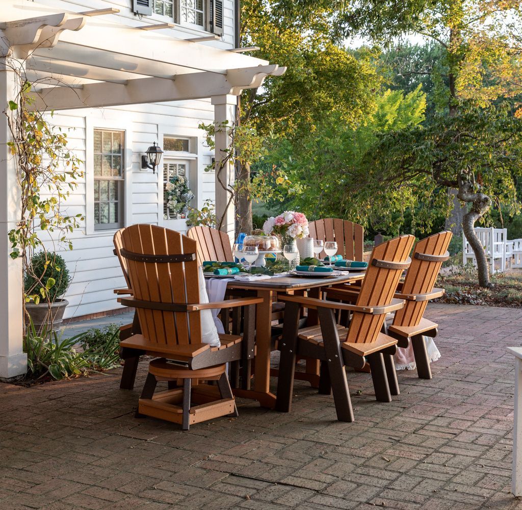 A table and chairs on a patio in front of a house