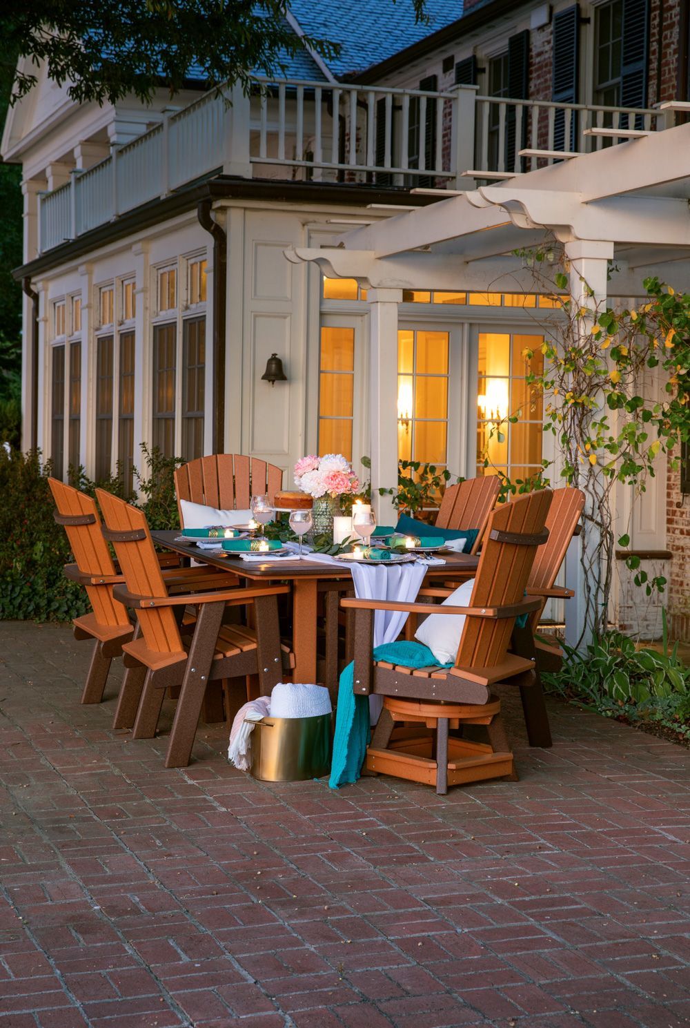 A patio with a table and chairs in front of a house.