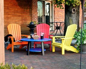 There are two chairs and a table on the patio.