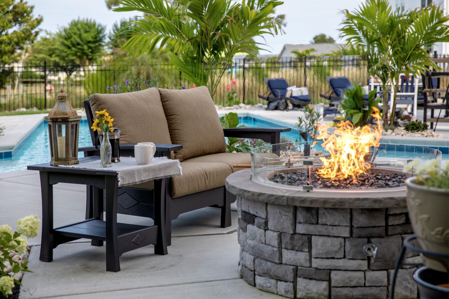 There is a fire pit in the middle of the patio. There is a fire pit in the middle of the patio.