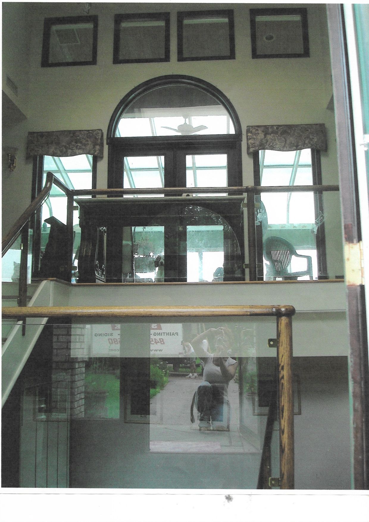 The sun is shining through the window and casting shadows on the wall