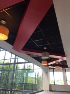 A person is painting a balcony with a roller.