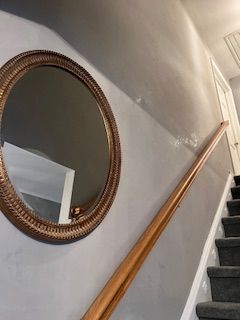 A man is pouring paint into a paint tray.
