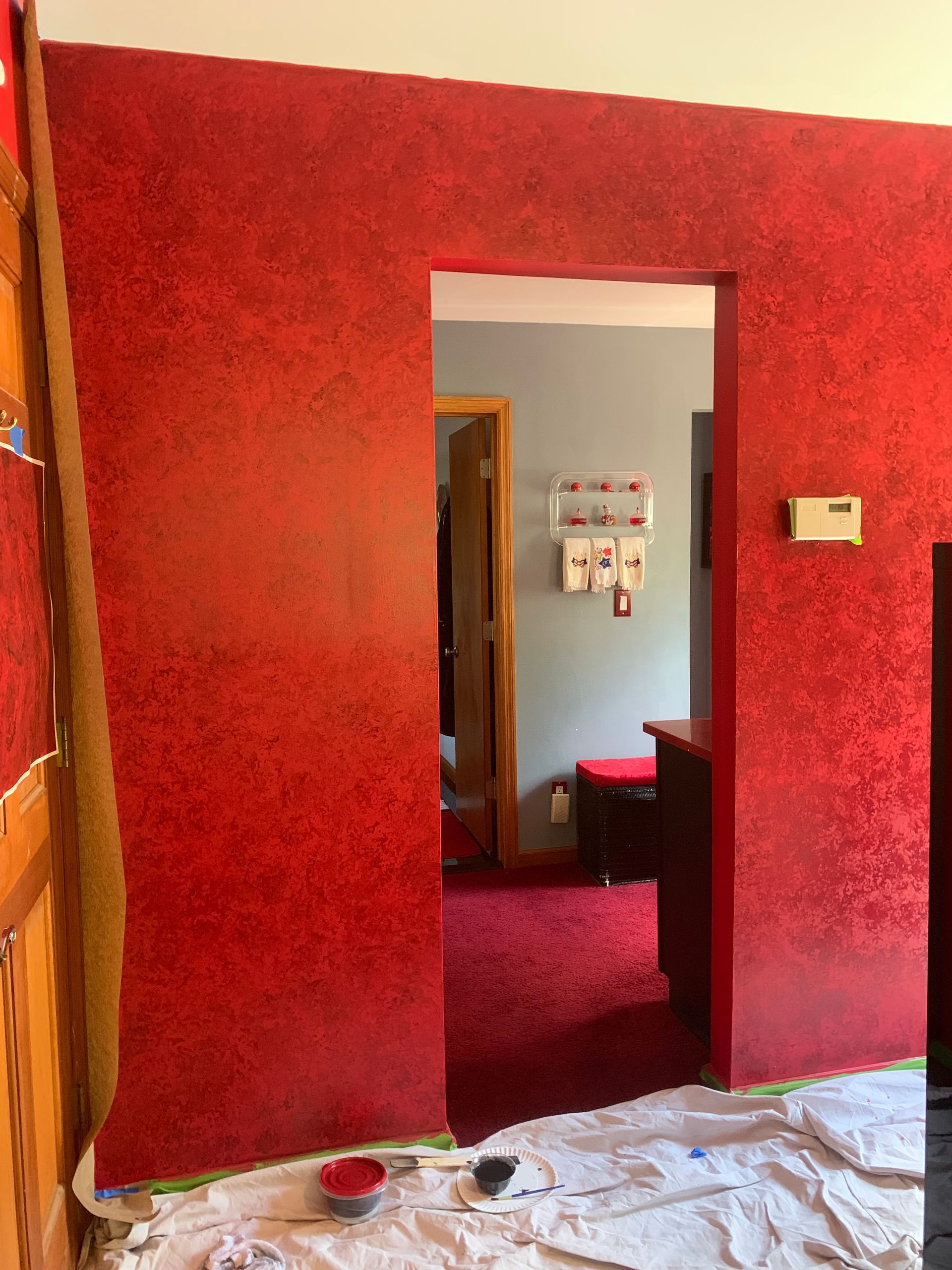 Three paint brushes and a paint roller on top of a color wheel