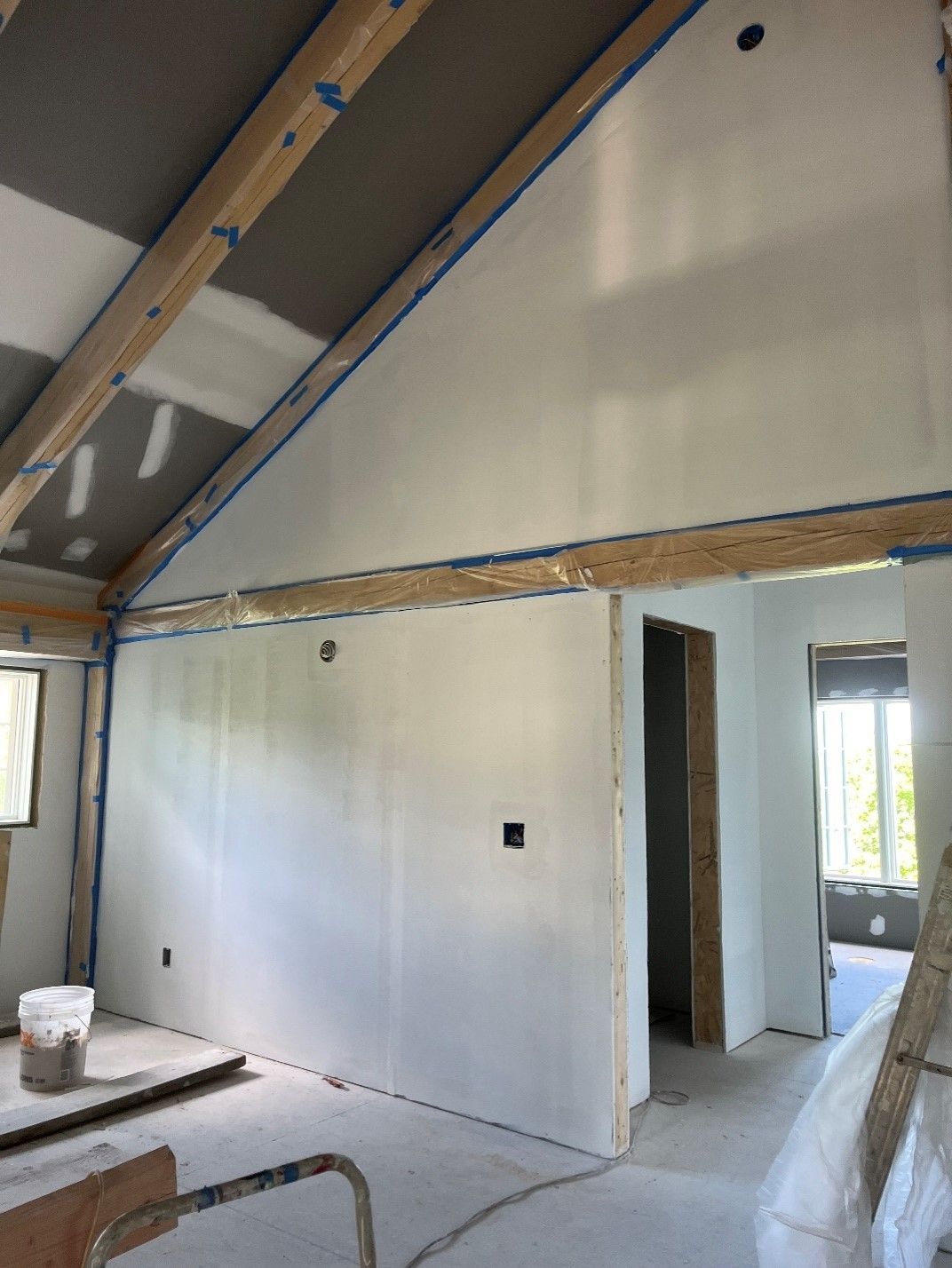 A room with a vaulted ceiling and white walls