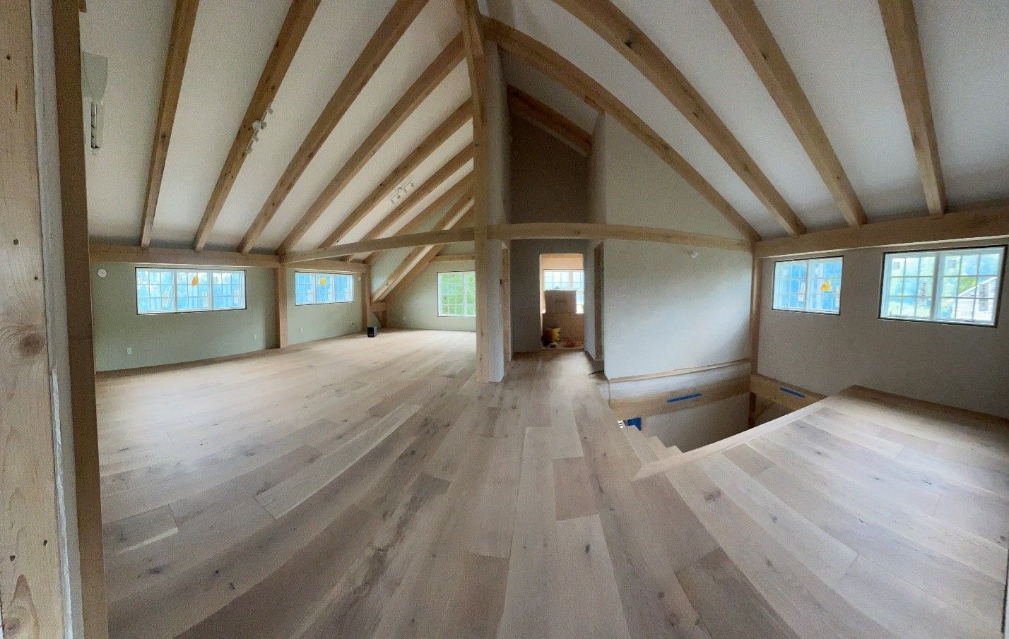 An empty room with wooden floors and a wooden ceiling