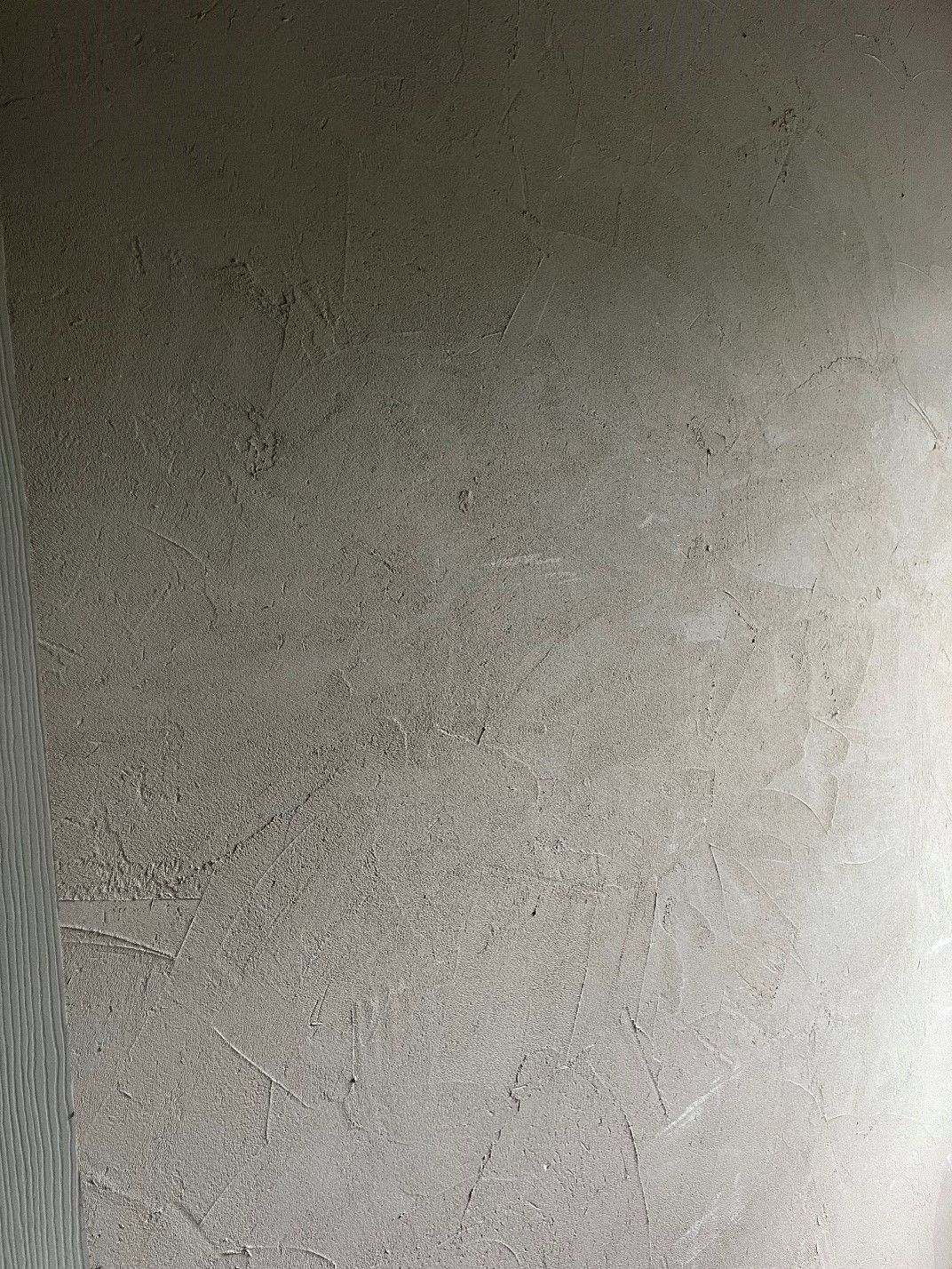 A close up of a gray wall with a grainy texture.