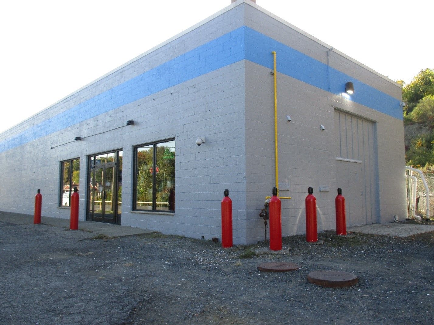 A white building with a blue stripe on the side