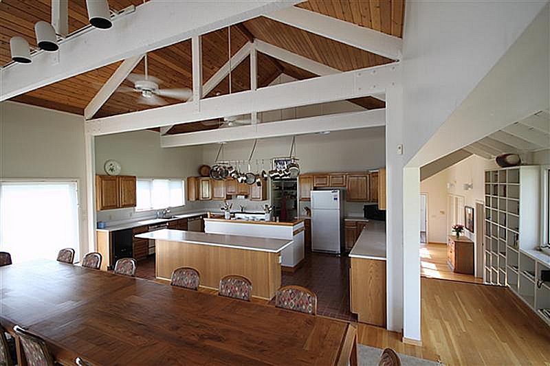 A kitchen with a large table and chairs in it