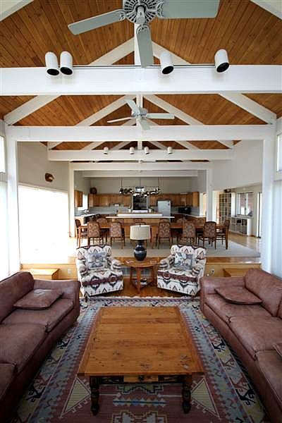 A living room filled with furniture and a ceiling fan