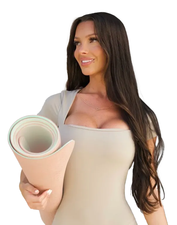 A woman is holding a yoga mat in her hands.