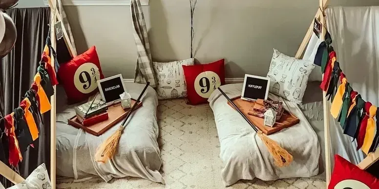 Two beds are sitting next to each other in a room with a teepee.