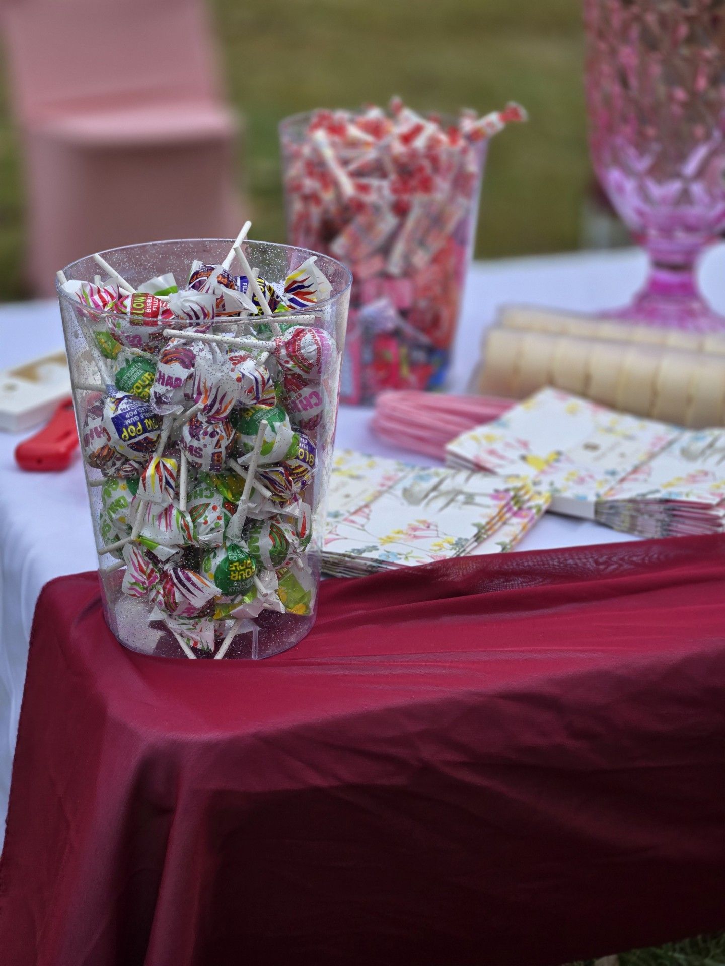 A jar filled with lollipops is sitting on a table.