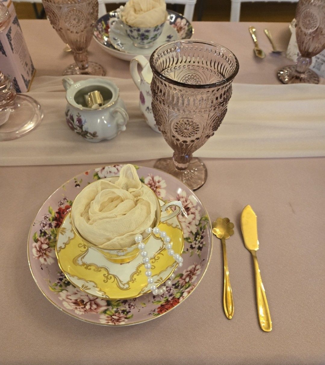 A plate with a rose on it sits on a table