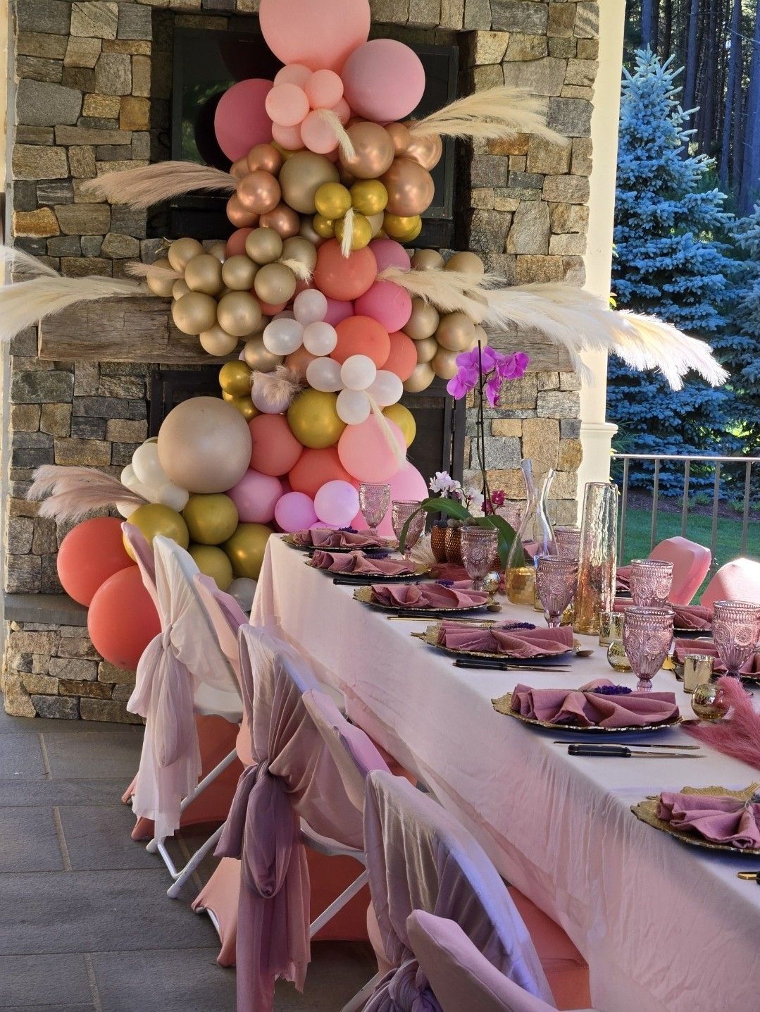 A long table with plates and balloons on it.