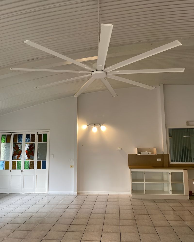 An Empty Room With A Ceiling Fan Hanging From The Ceiling — Glittering Cleaning Service In Townsville, QLD