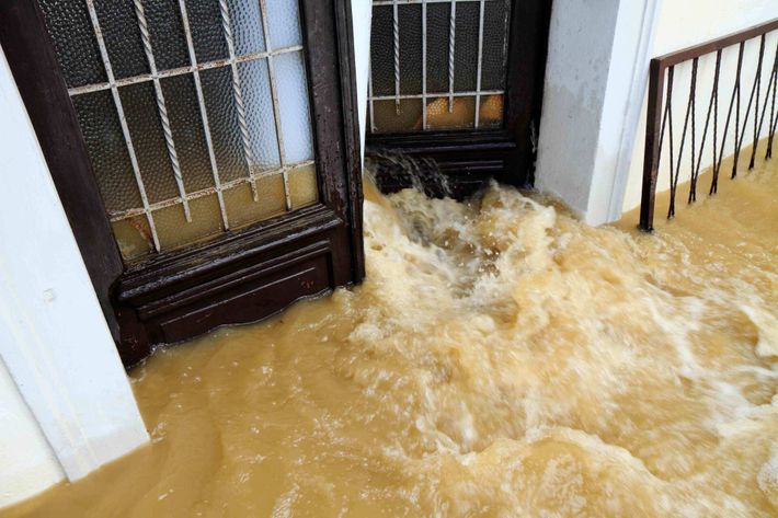 Muddy Water Pouring Through The Entrance Door — Philadelphia, PA — Aclaim Adjustment Agency