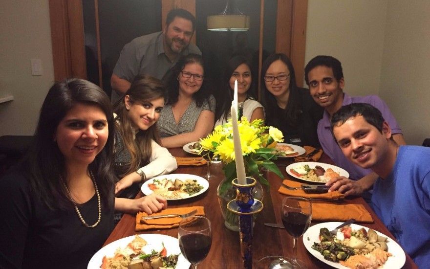 A group of people are sitting at a table with plates of food.