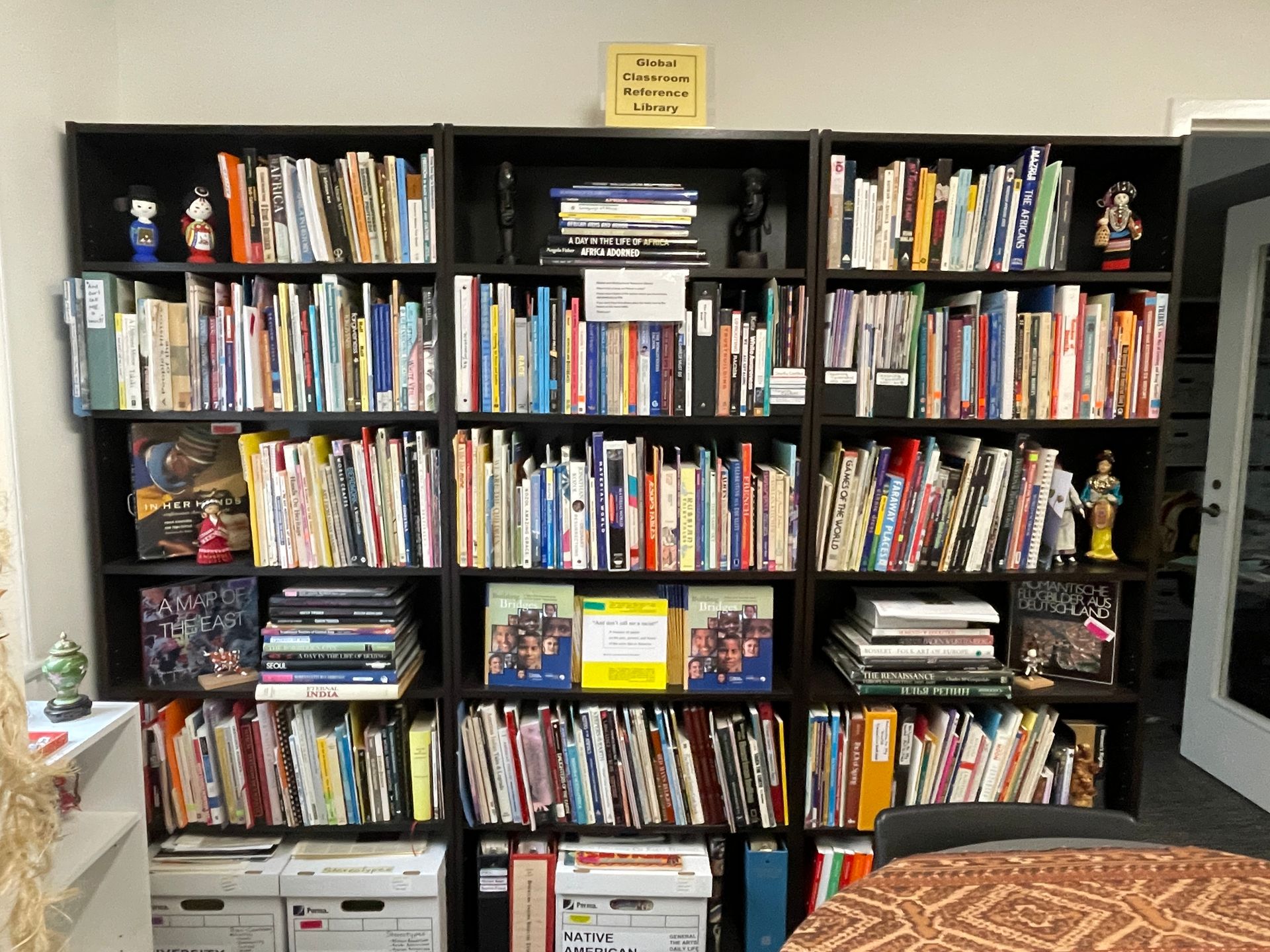 A bookshelf filled with lots of books and pictures