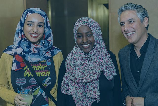 A group of people are posing for a picture together and smiling.