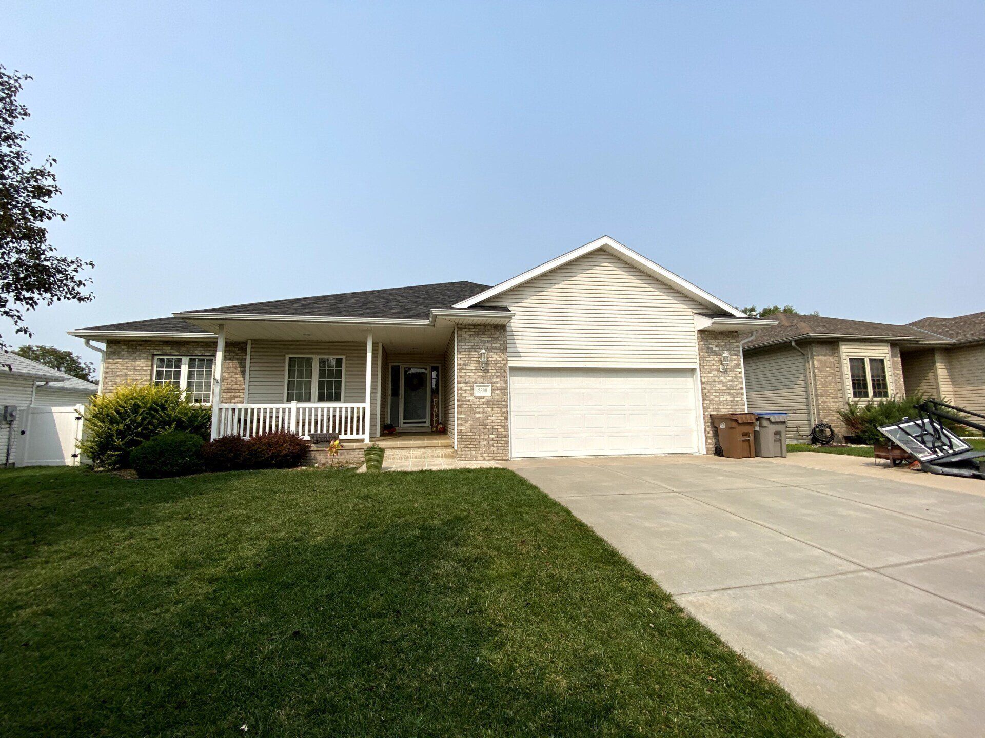 A house with a white garage door and a concrete driveway