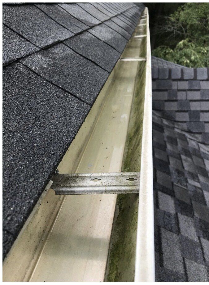 A close up of a gutter on a roof.