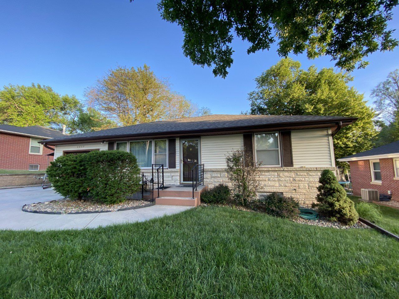 A house with a lush green lawn in front of it