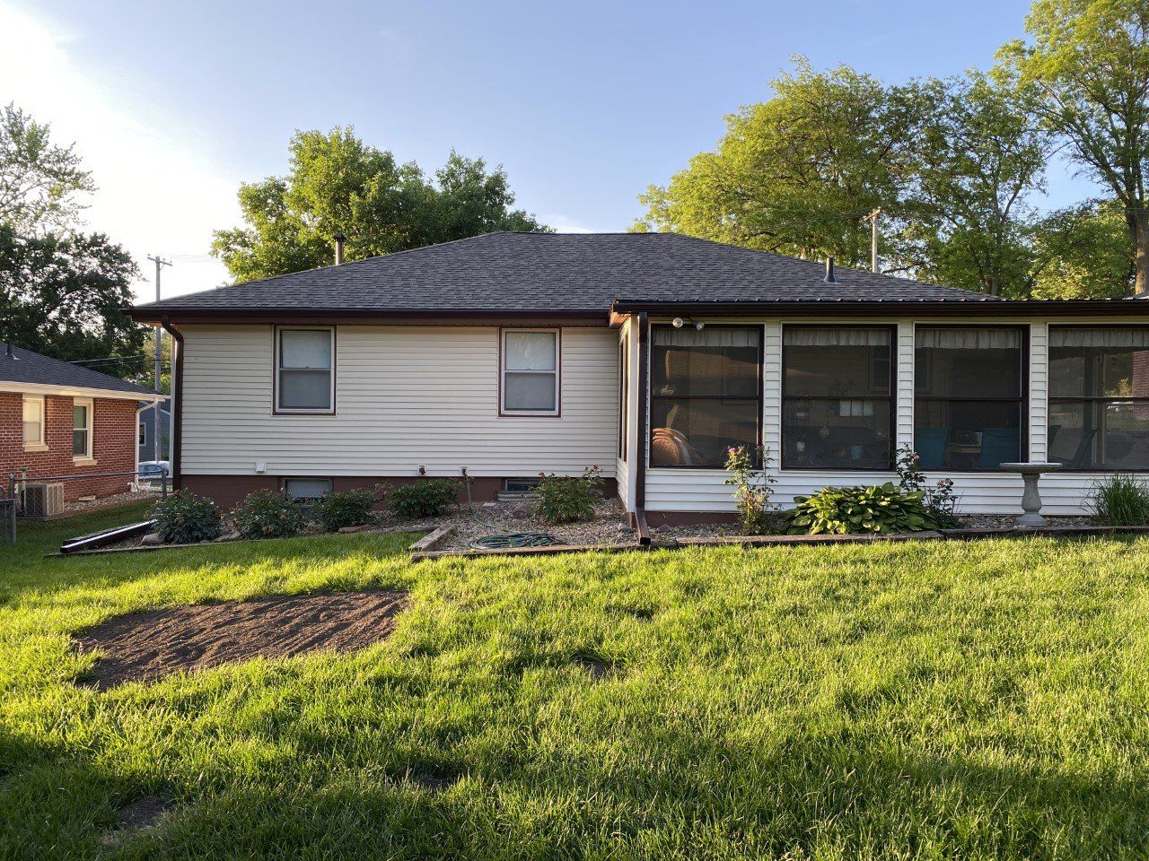 A house with a large lawn in front of it.