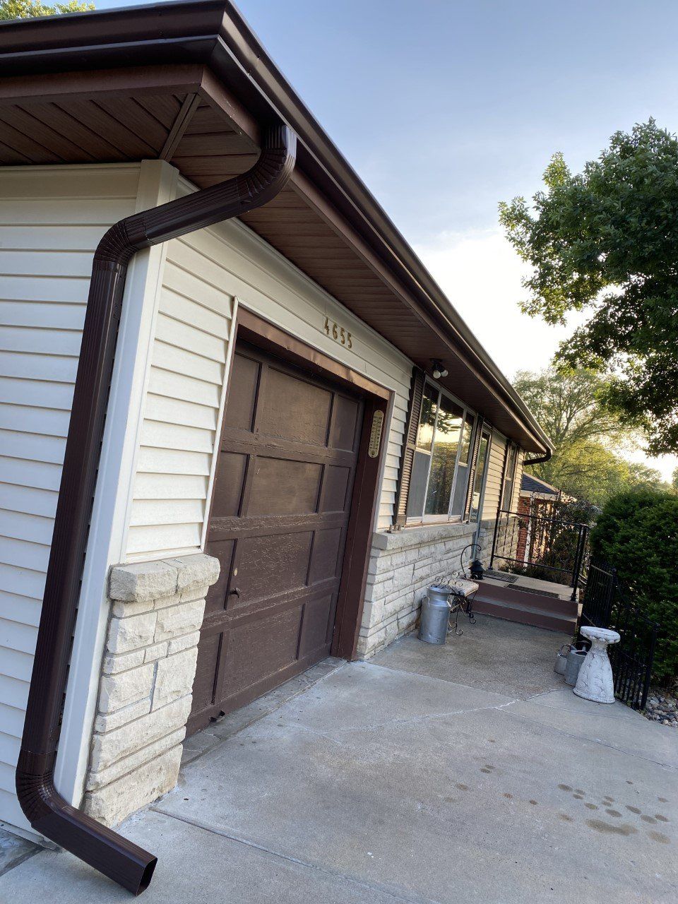 A house with a brown garage door and a brown gutter