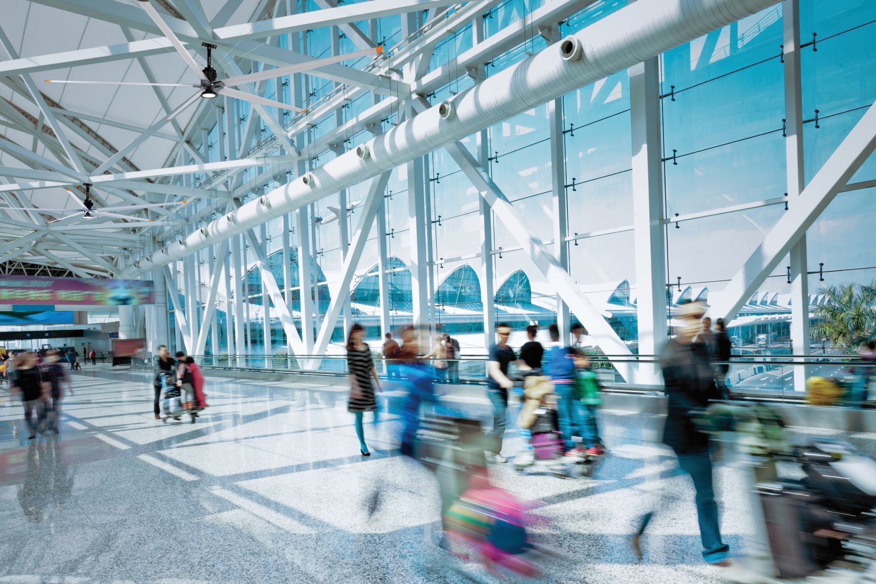 A blurry picture of people walking through an airport.