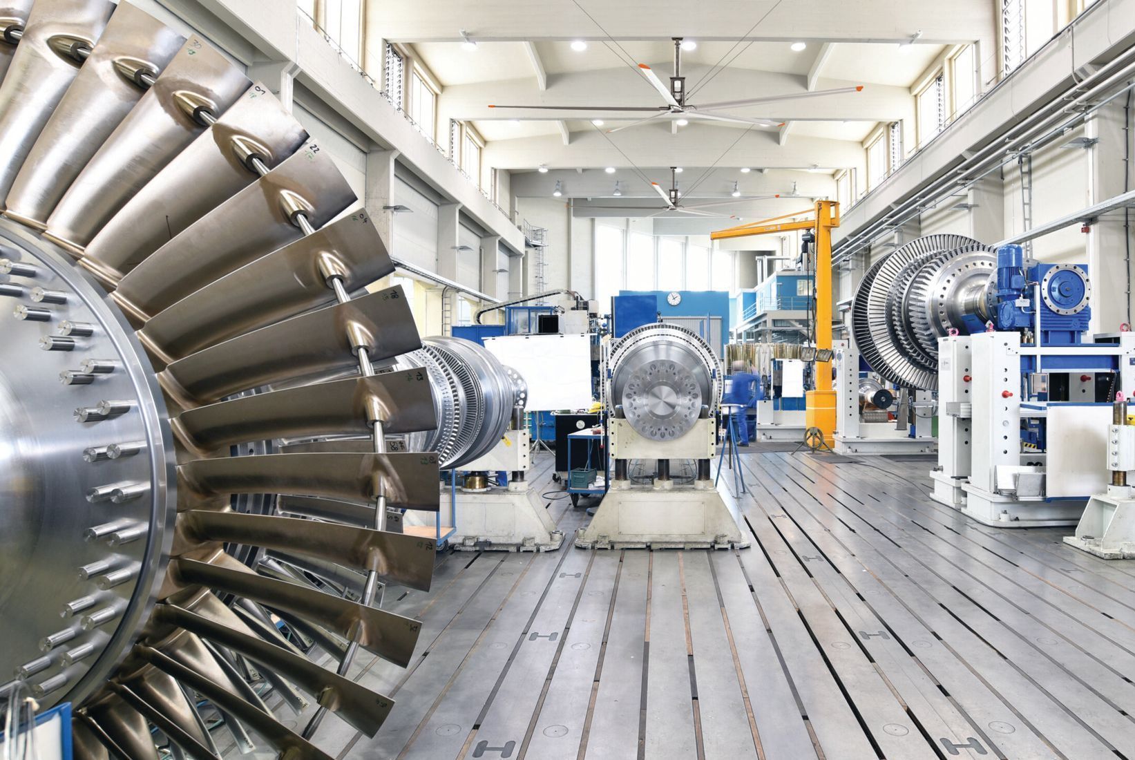 A factory filled with lots of machinery and a large turbine.