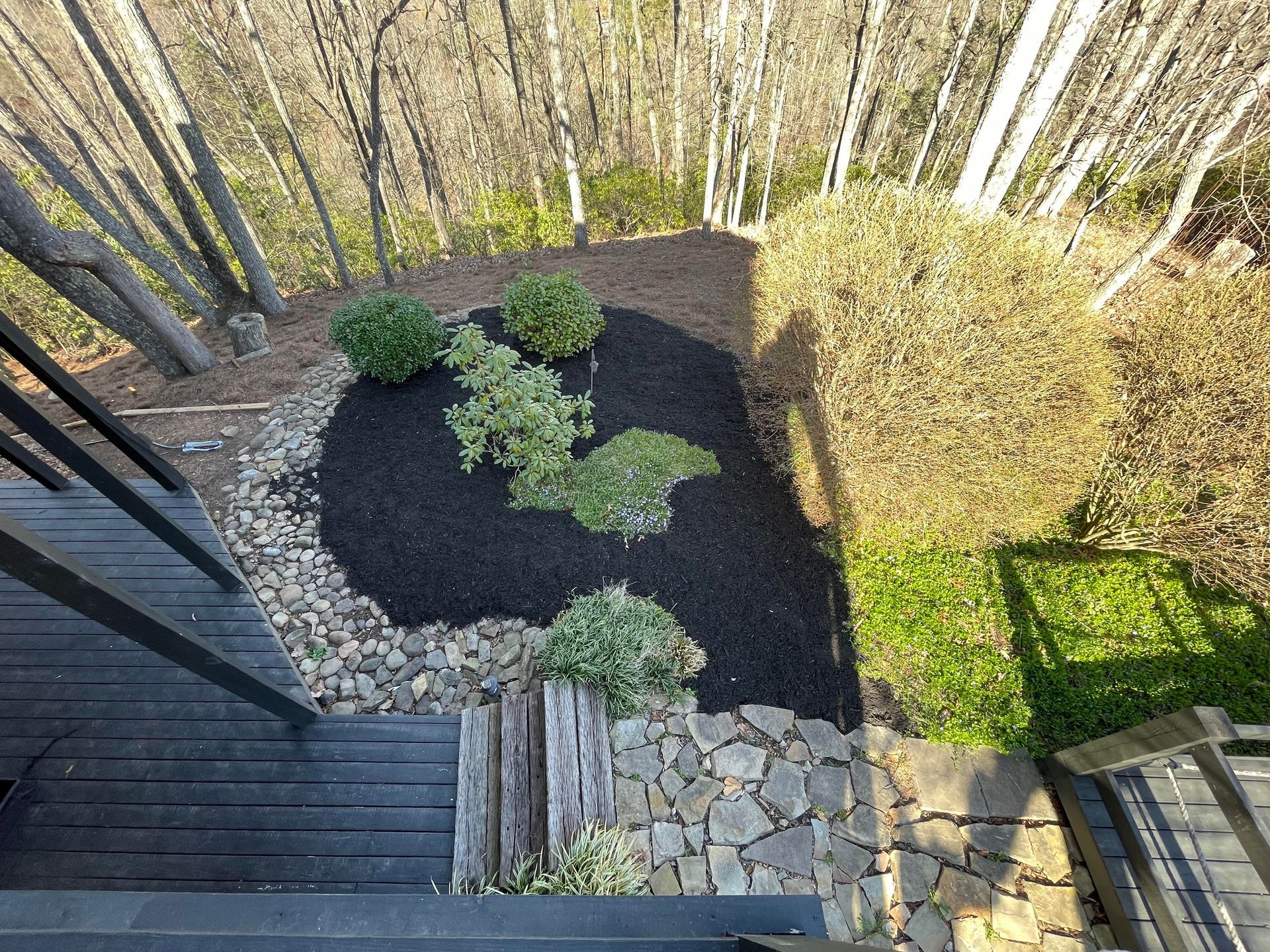 An aerial view of a garden with trees in the background.