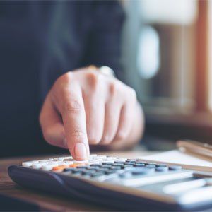 Tax Planning — A Business Woman Using Calculator in Hesperia, CA