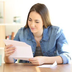 Insurance — Relaxed Lady Reading A Letter At Home in Hesperia, CA