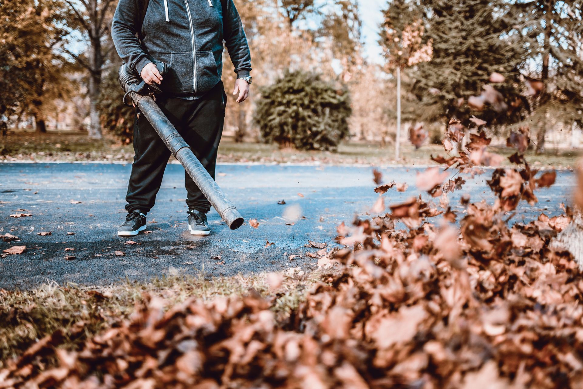 A Man Clearing Leaves in the Street — St. Charles, MI — Acorn Tree Service & Landscape Inc
