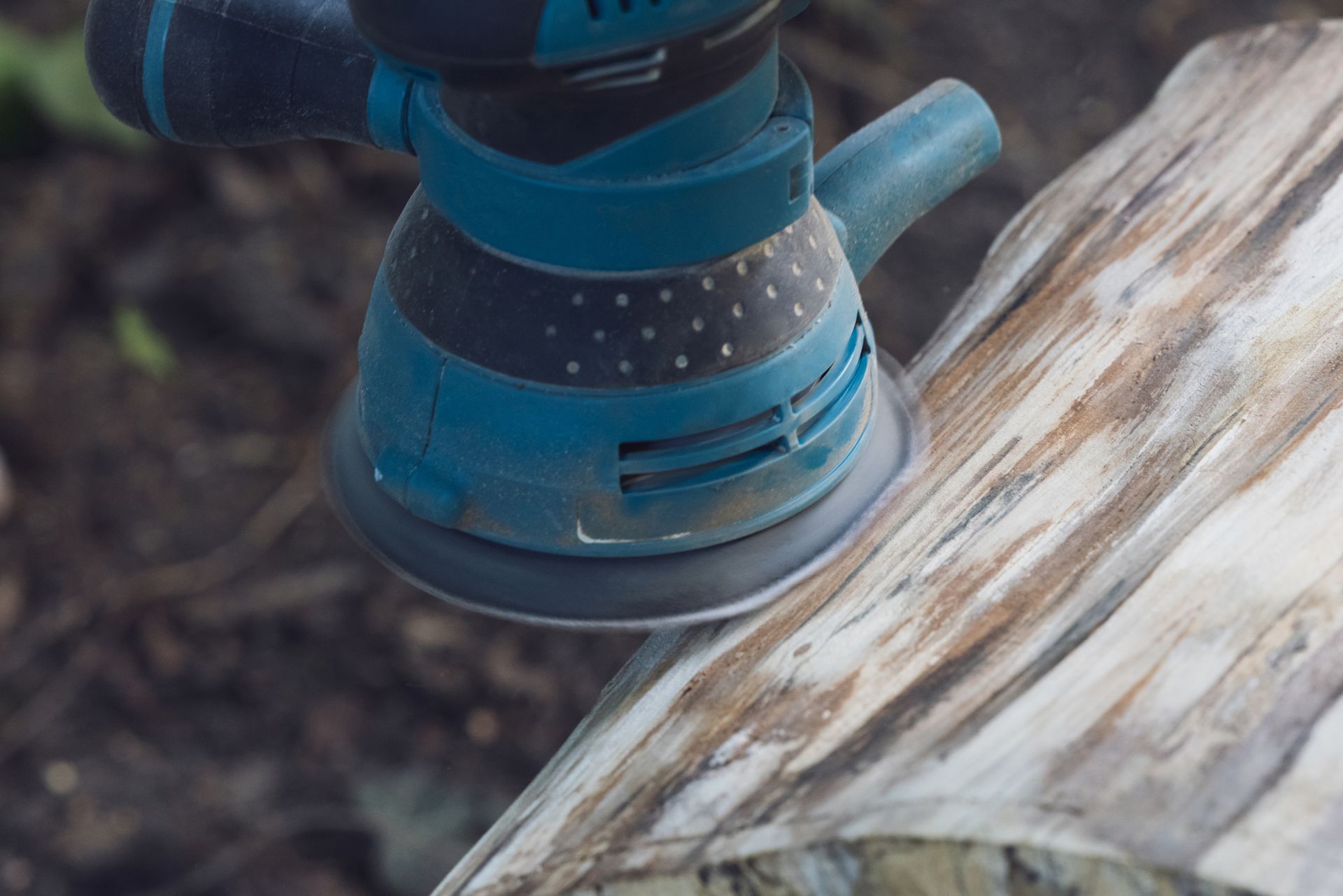 A Machine Grinding a Tree Stump — St. Charles, MI — Acorn Tree Service & Landscape Inc